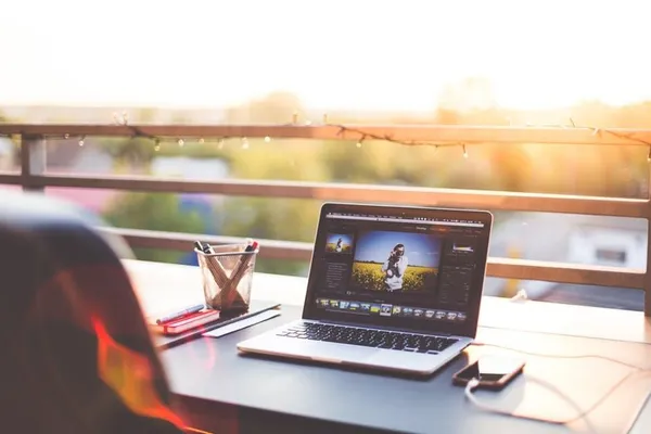 Laptop on a balcony table at sunset